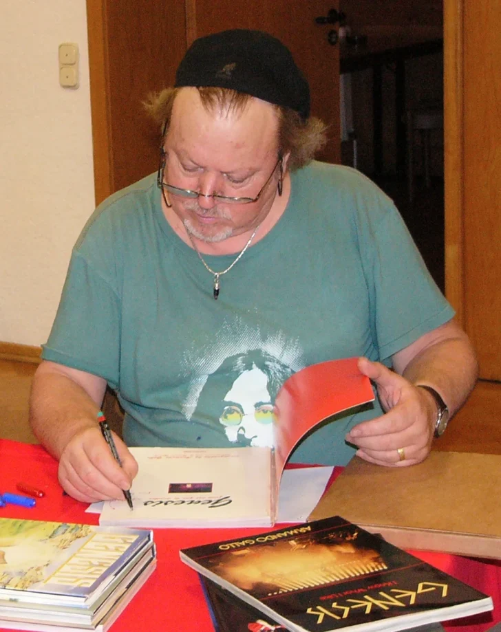 Armando Gallo signing books